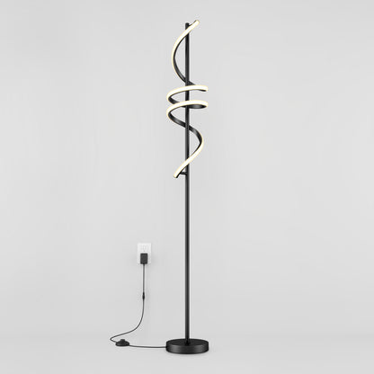 The Artika Coda modern LED floor lamp 5CCT features a black stand with three spiral LED light tubes, dimmable for customizable ambiance, standing against a white wall and plugged into a wall outlet.