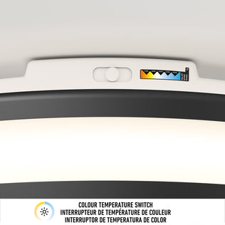 Close-up of Artika Hemisphere 15 in. LED flush mount’s adjustable brightness switch, with multilingual label and icon below.