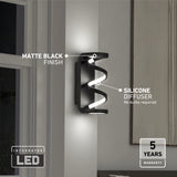 A modern wall light with a matte black finish and silicone diffuser emits LED light. Labels point to its features. A 5 years warranty badge and Integrated LED text are displayed in the bottom corners.