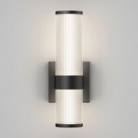 The Artika Mirado modern LED wall sconce 5 CCT features two vertically aligned frosted ribbed glass shades on a matte black square backplate, offering soft, even light and versatile style.