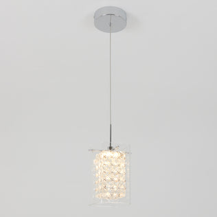 The Artika Crystal Cube 1-light LED pendant light features a chrome ceiling mount, a single cord, and a textured crystal-like cylindrical glass shade, shown illuminated against a plain white background.