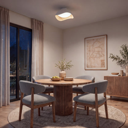 An Adara 15 in. (38 cm) Modern LED Flush Mount Ceiling Light 5 CCT illuminates a round dining table with four chairs.