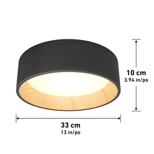 The Artika Alton LED flush mount is a modern, round, dimmable ceiling light with a black exterior and wood-textured interior. It emits soft light and measures 33 cm (13 in) in diameter by 10 cm (3.94 in) high.