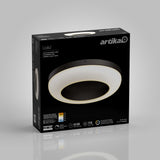 A black Artika Louka LED flush mount ceiling light in its packaging, featuring a circular modern design with a glowing ring, product details, and icons for brightness, lifespan, and warranty on the box.