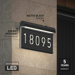 The Bowen modern LED outdoor address wall light 5 CCT by Artika displays illuminated numbers “18095” on a matte black stone wall. Labels highlight its energy efficiency, integrated LED, and 5-year warranty.