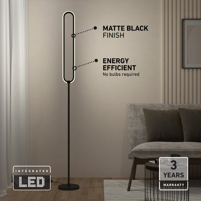 The Artika Leni dimmable LED modern floor lamp with a matte black finish stands in the living room near a sofa. Labels highlight “energy efficient” and “matte black finish.” Icons show integrated LED and a 3-year warranty.