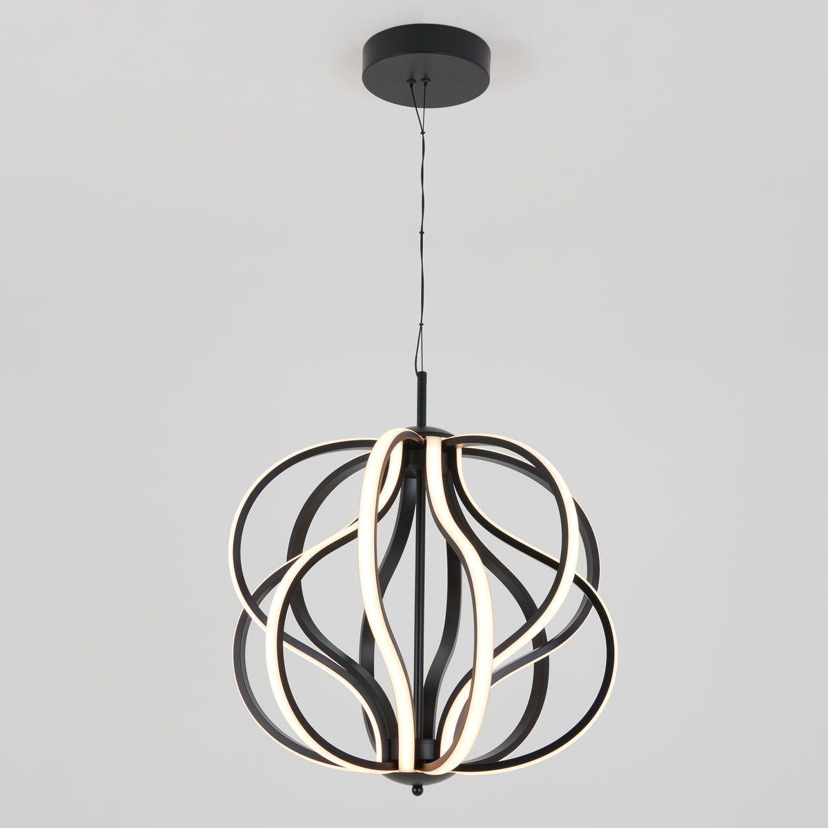 A modern pendant light with curved black metal bands and integrated LED strips forming an abstract, spherical shape, suspended from a black ceiling mount by a thin cord.