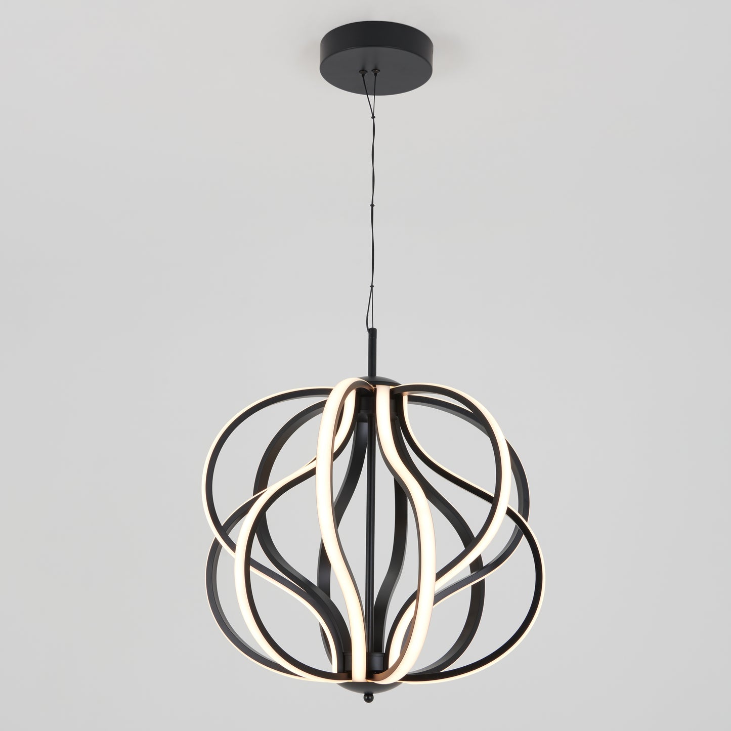 The Artika Meridian LED pendant light features curved, looping black metal bands with integrated LED strips, suspended from a black ceiling mount against a plain light gray background.