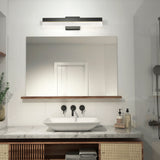 A modern bathroom with a marble countertop, vessel sink, wall-mounted black faucet, large mirror, and a rectangular light fixture above. Towels, soap, and a plant are neatly arranged on the counter and shelves.