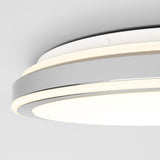Close-up view of a modern, circular ceiling light fixture with a sleek, minimalist design in white and gray, and a glowing LED ring around its edge.