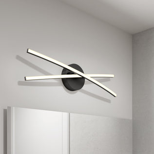 The Artika Orly modern LED bathroom vanity light 3 CCT features two curved bars crossing over a round black base—ideal for mounting above a mirror to enhance modern decor and provide perfect bathroom lighting.