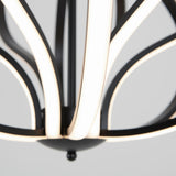 Close-up of a modern chandelier with curved black metal arms and integrated LED light strips, set against a neutral gray background.