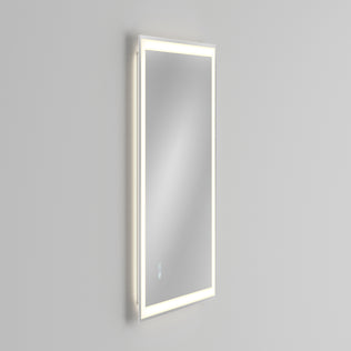 The Artika Sofia LED mirror 3 CCT with defogger features a sleek, modern rectangular design with an illuminated LED border and touch controls, shown wall-mounted at an angle against a plain light gray background.