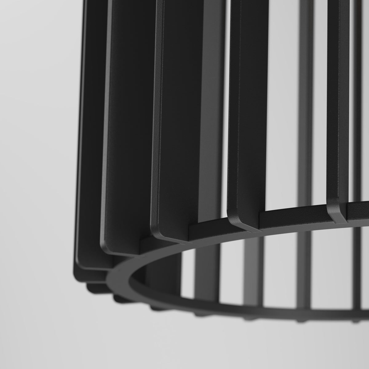 Close-up of a black, modern, geometric metal lampshade with vertical bars and a circular base against a light gray background.
