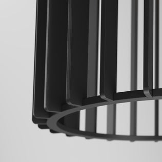 Close-up of the Artika Gatsby Mini modern mid-century pendant light, featuring a black metal shade with vertical slats and a circular base, set against a plain light background.
