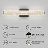 Modern wall-mounted LED light fixture with a crystal design, shown lit. Feature icons below highlight: LED integrated, dimmable, 2000 lumens, 50,000 hours lifespan, easy installation, and selectable white technology.