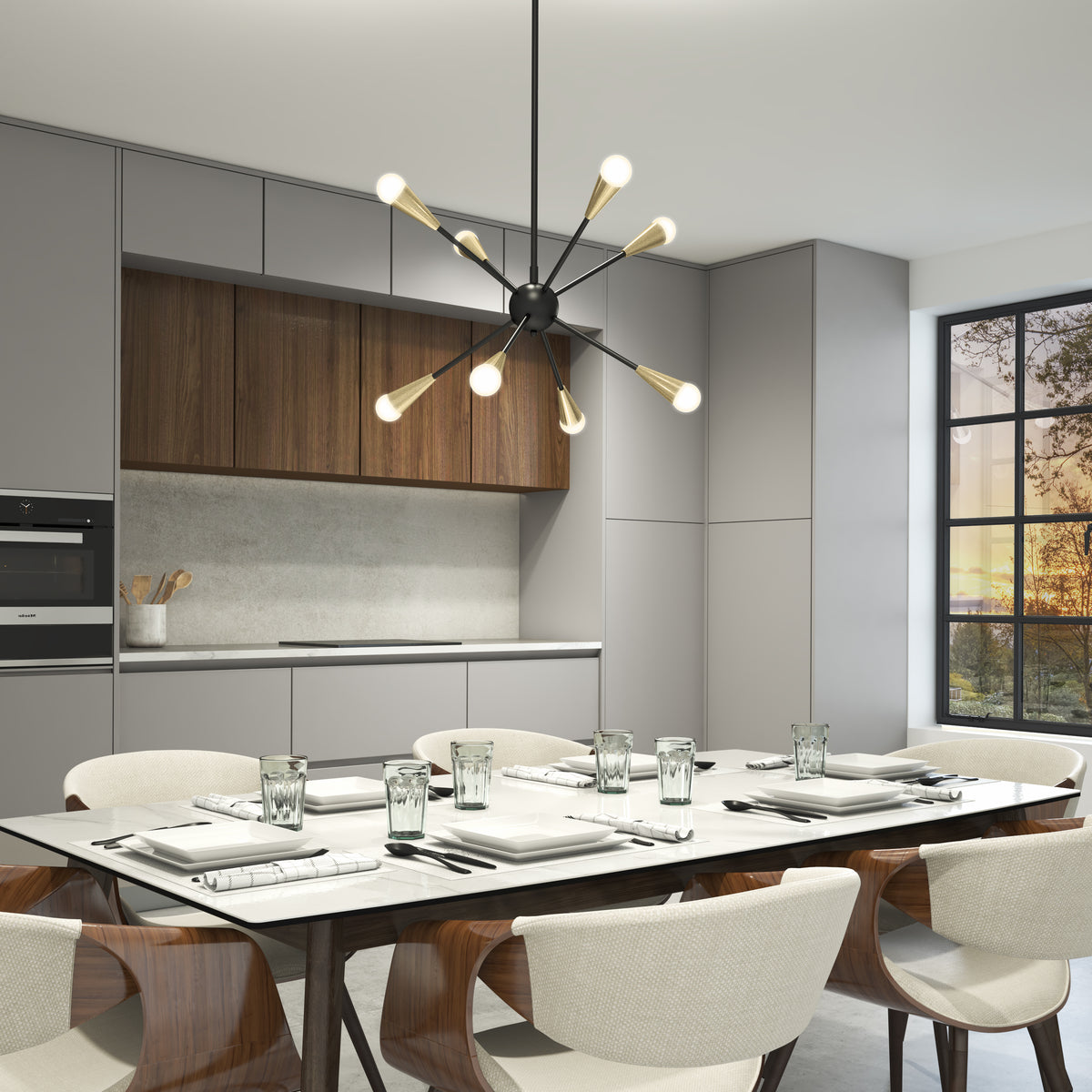Modern kitchen and dining area with a white table set for six, wooden chairs, minimalist gray cabinets, wood accents, and a contemporary chandelier hanging above. Large window lets in natural light.