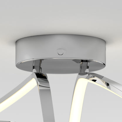 A close-up of the Artika Loop modern LED flush mount light 3 CCT, featuring a shiny chrome base and curved LED strips extending downward.