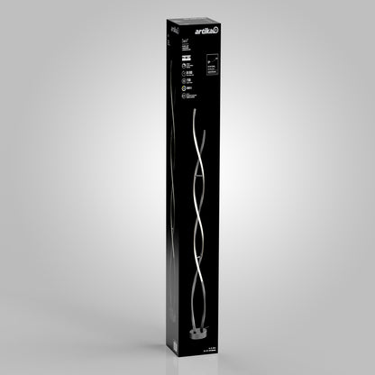 Tall black box with Swirl modern LED floor lamp by Artika, ideal for modern living rooms; pictured on a light gray background.